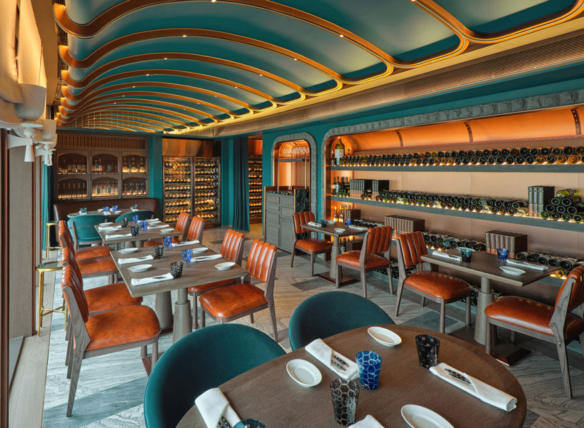 sky-high ‘the cellar’ by andré fu studio seats 28 diners and holds 400 premium wine labels