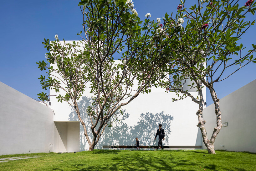 interior fish pond surrounds the living area of 23o5 studio's serene house in vietnam