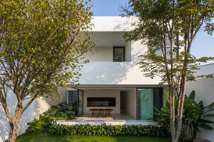 interior fish pond surrounds the living area of 23o5 studio's serene house in vietnam