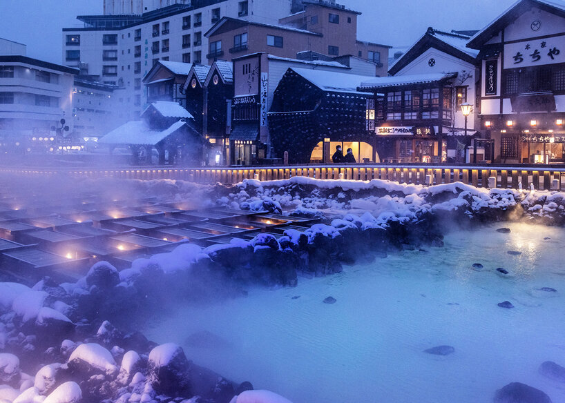 kengo kuma adds local stone to hot spring inn in kusatsu, japan