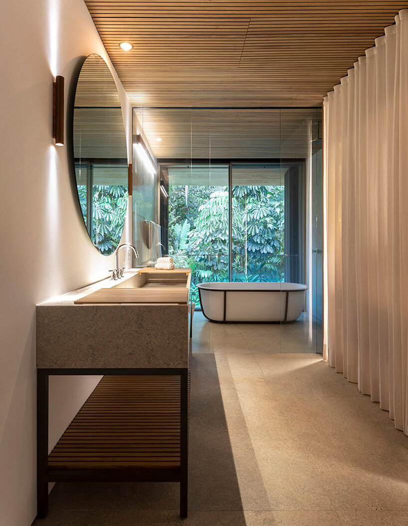L-shaped weekend house by jacobsen arquitetura enjoys close connection to nature in são paulo - 2