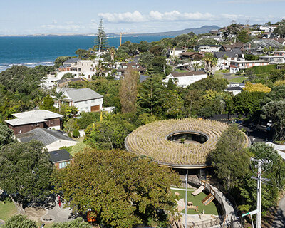 smith architects tops learning center in new zealand with circular green roof canopy