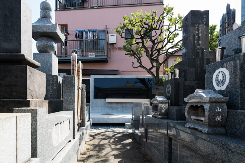 black tones unify japanese temple's ossuary + tree burial facility by