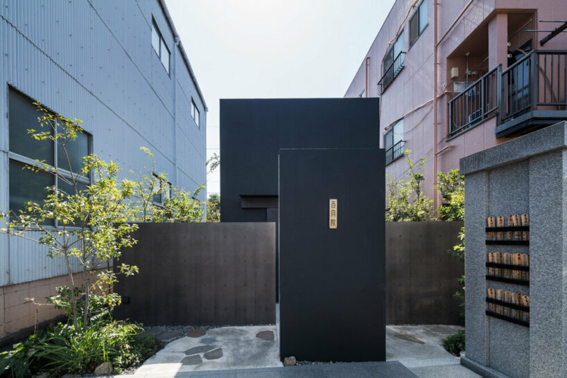 the building is sandwiched between condominiums and factories