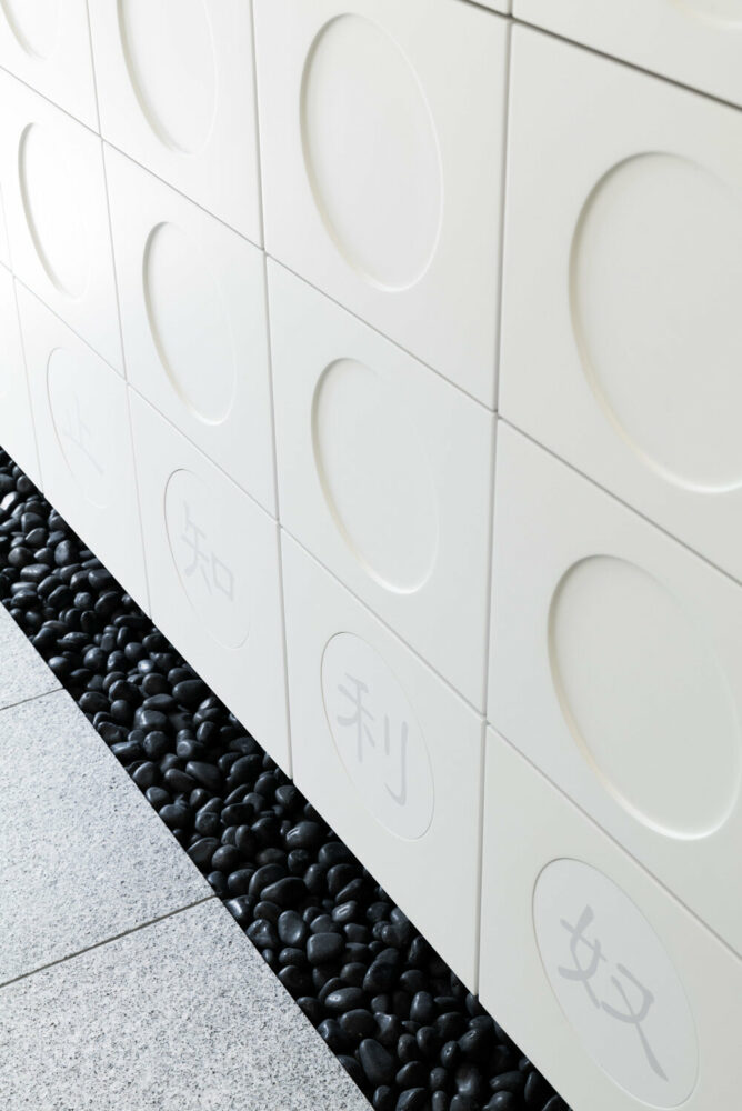 black tones unify japanese temple's ossuary + tree burial facility by