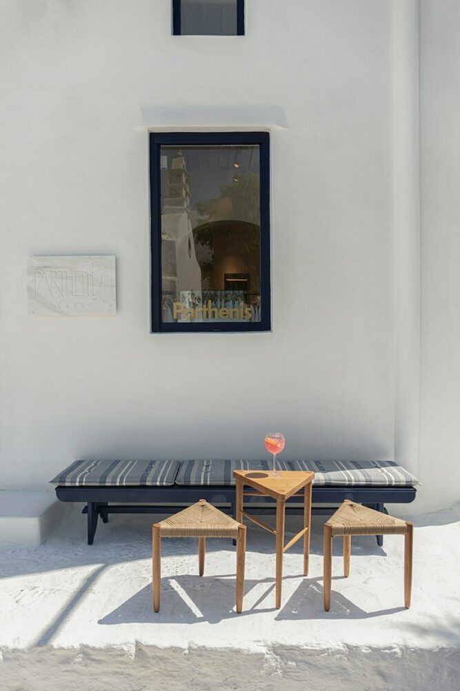 nesting tripod stools and side tables can be reconfigured around low benches with striped cushions