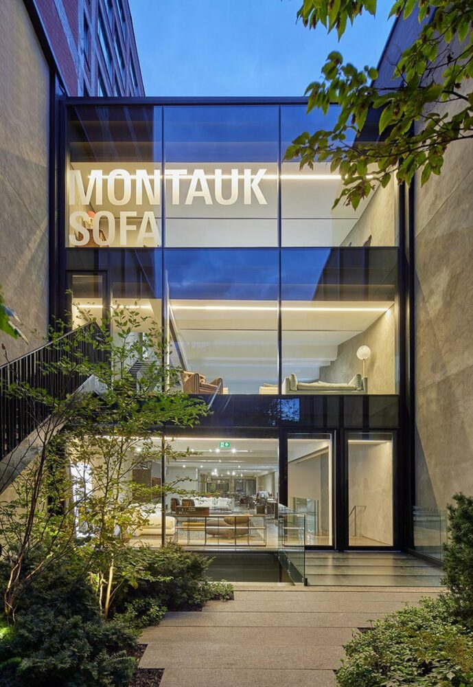 the façade of large-format glass extends from the third story to the basement, providing each showroom level with natural light and views of the garden