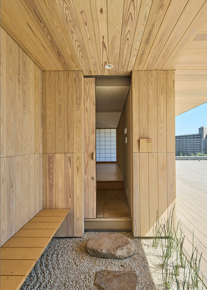 kengo kuma wraps yokohama campus building in a facade of folding timber panels