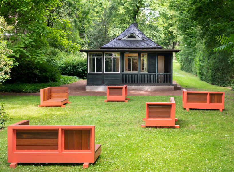 andrea zittel created five bench sculptures in soft red to gather people at esters garden house