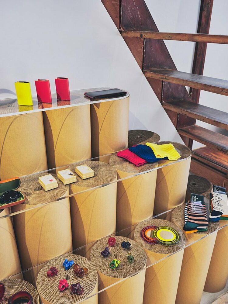 glass shelves rest upon rolls of card 