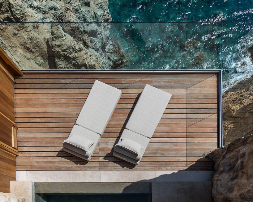 wellness hotel ‘acro suites’ occupies carved-out caves along coastal cliffs of crete