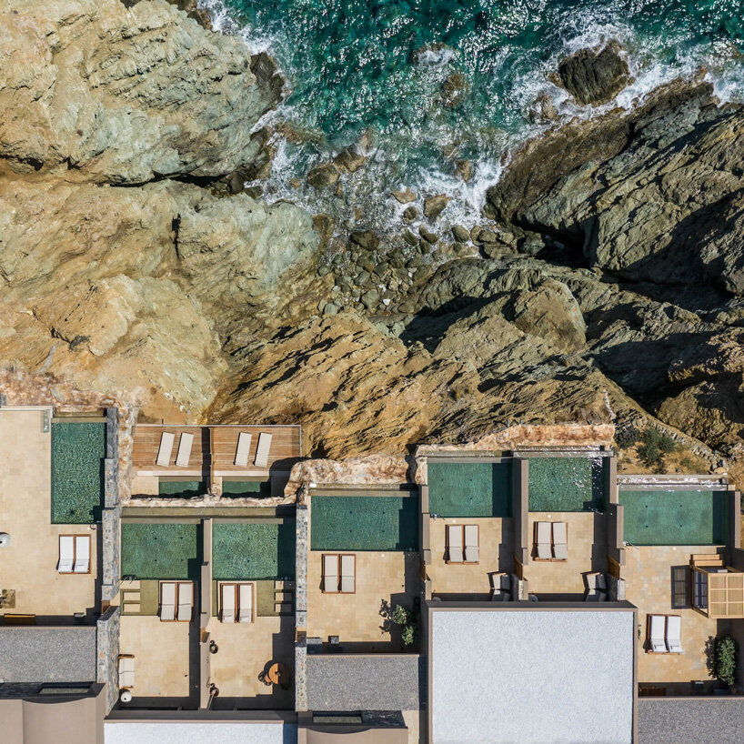 wellness hotel ‘acro suites’ occupies carved-out caves along coastal cliffs of crete