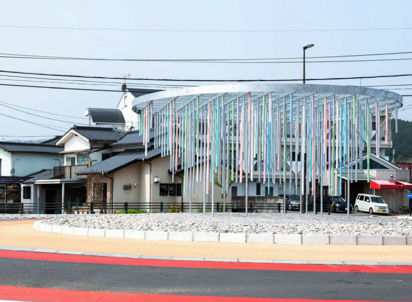 roundabout installation by takao shiotsuka atelier drips like paint via colored steel pipes