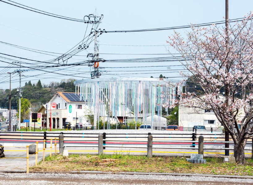 roundabout installation by takao shiotsuka atelier drips like paint via colored steel pipes
