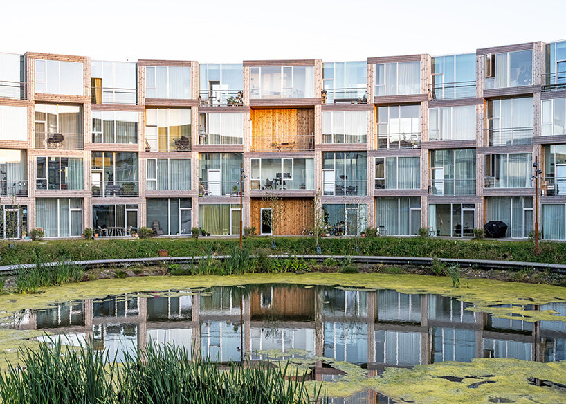 BIG's modular housing spirals around central pond in danish sustainable suburb