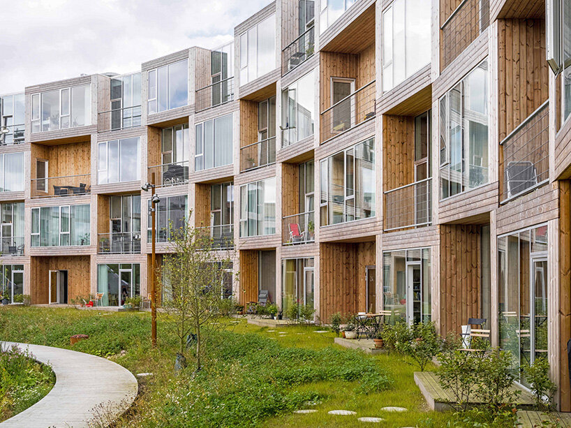 BIG's modular housing spirals around central pond in danish sustainable suburb
