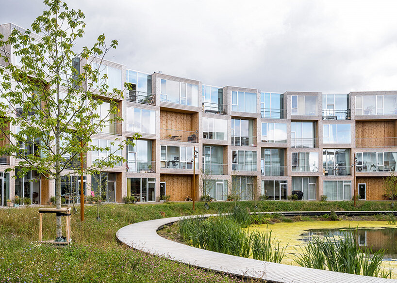 BIG's modular housing spirals around central pond in danish sustainable suburb