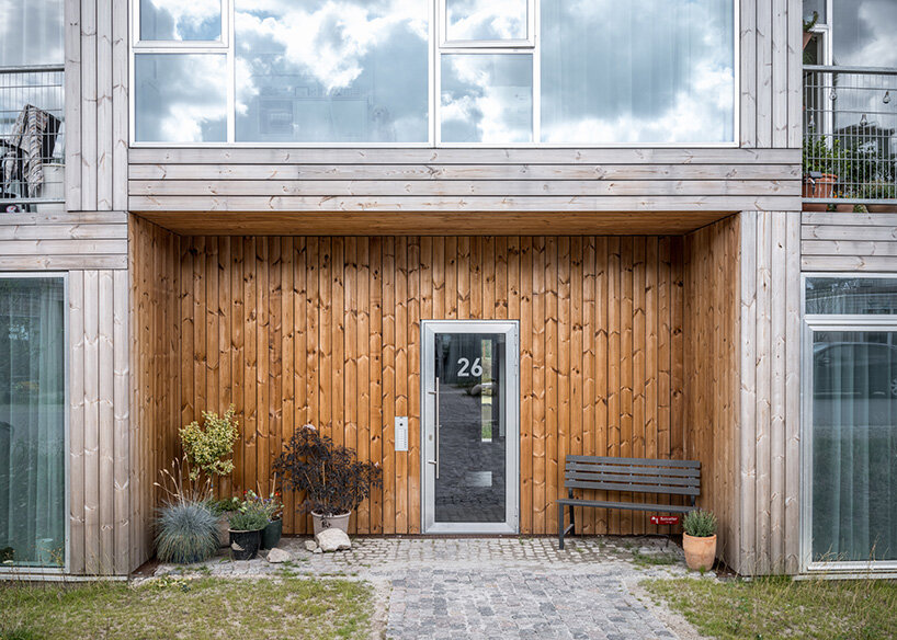 BIG's modular housing spirals around central pond in danish sustainable suburb