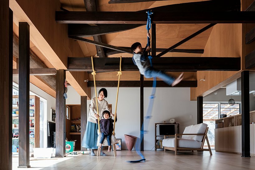 ropes hang from the wooden beams for the children to play with 