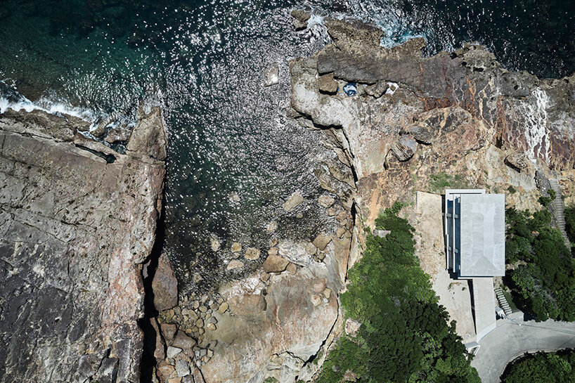 ninkipen! perches concrete seaside house on rugged national park landscape in japan
