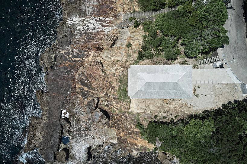 ninkipen! perches concrete seaside house on rugged national park landscape in japan