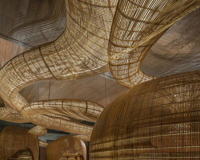 with undulating rattan, enter projects breathes new life into gallery in thailand