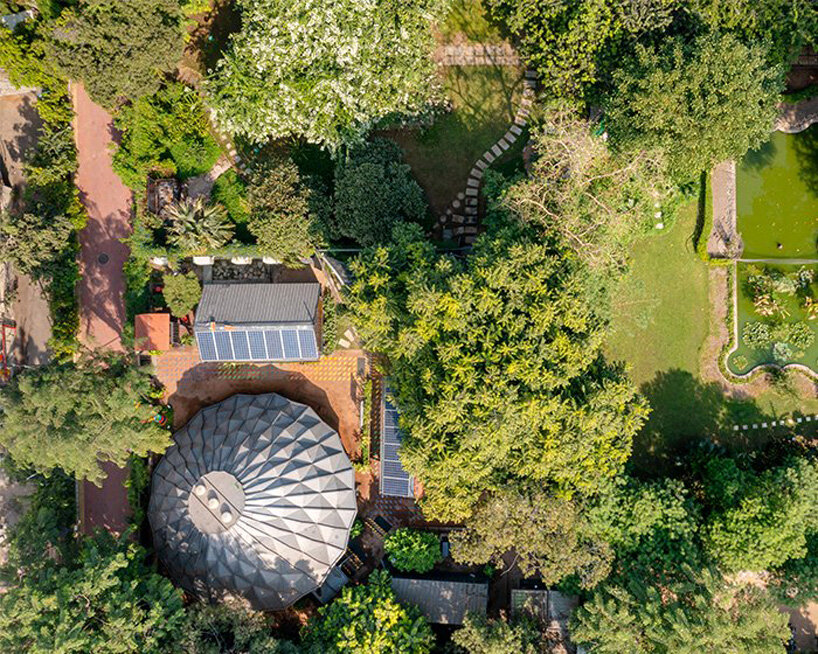 parametric metal tent with ridge paneled facade serves as multipurpose events space by andblack studio in india