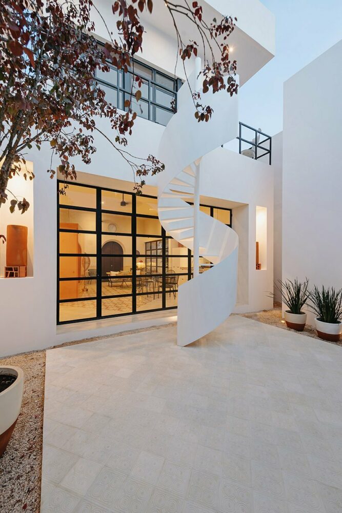a minimal and elegant staircase spirals in the rear garden