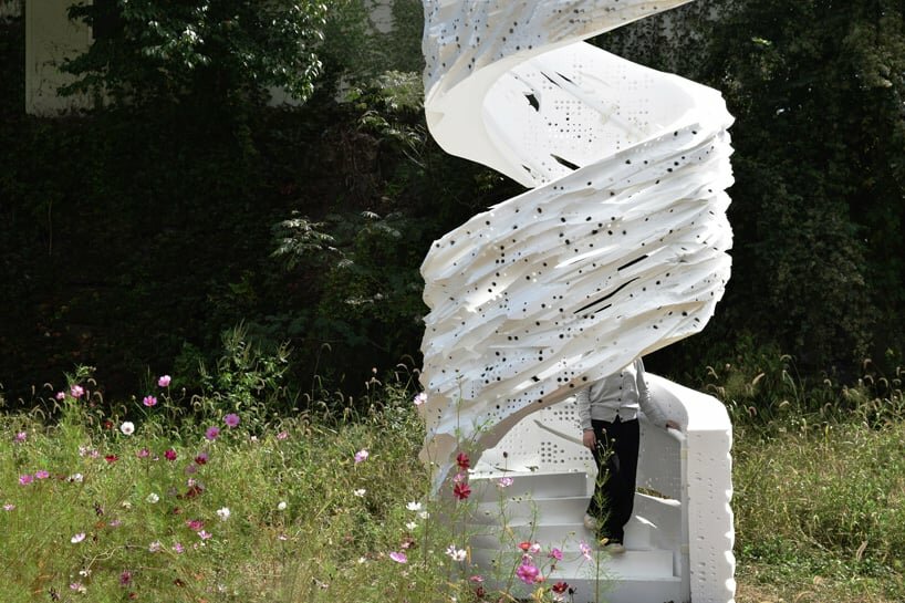 the decomposing robot-generated pavilion stands in natural surroundings