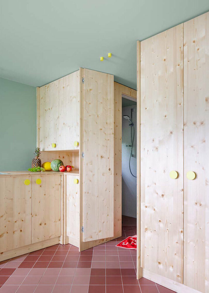 neon yellow accents accentuate the rustic wooden furnishings