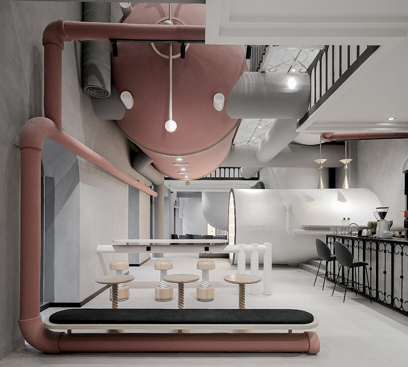 pink reaction tanks hover above x+living's commercial center in shanghai