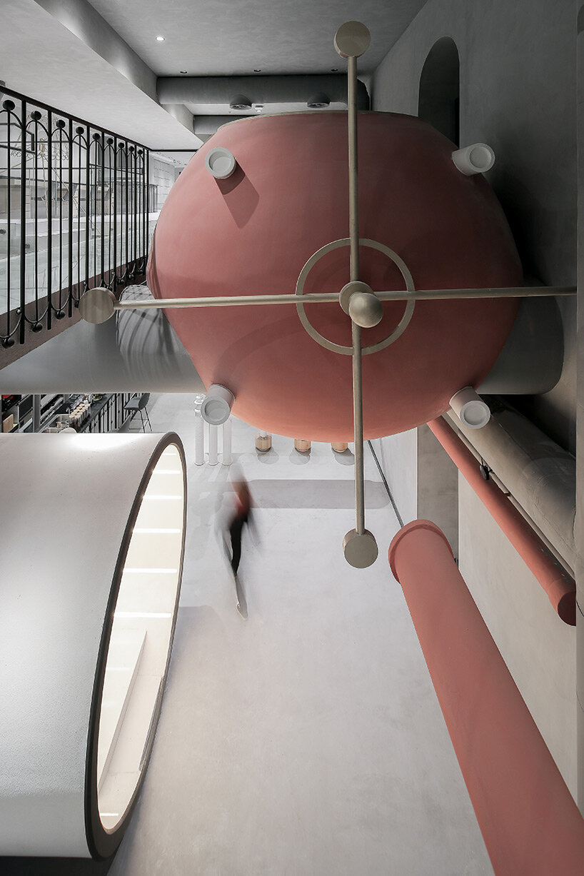 pink reaction tanks hover above x+living's commercial center in shanghai