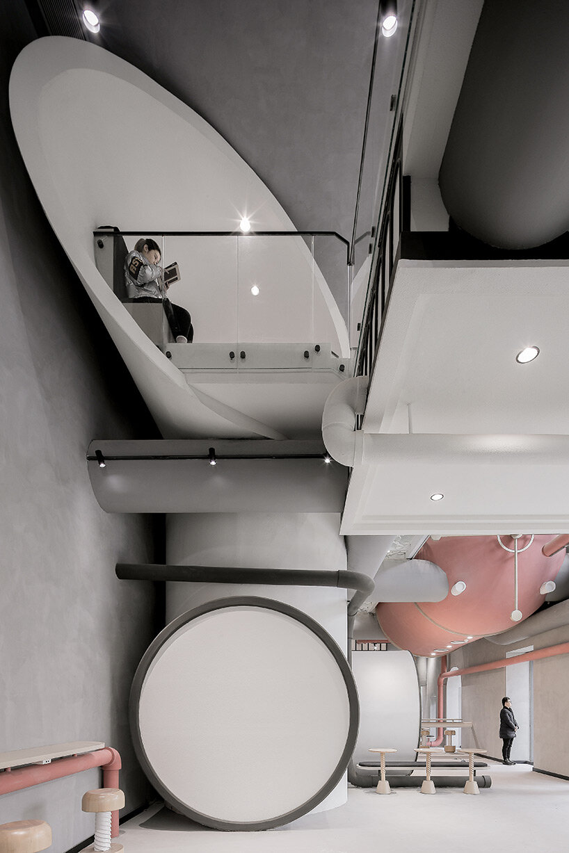 pink reaction tanks hover above x+living's commercial center in shanghai