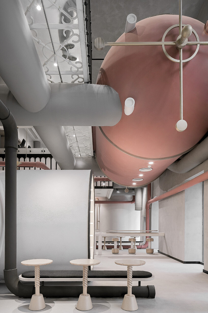 pink reaction tanks hover above x+living's commercial center in shanghai