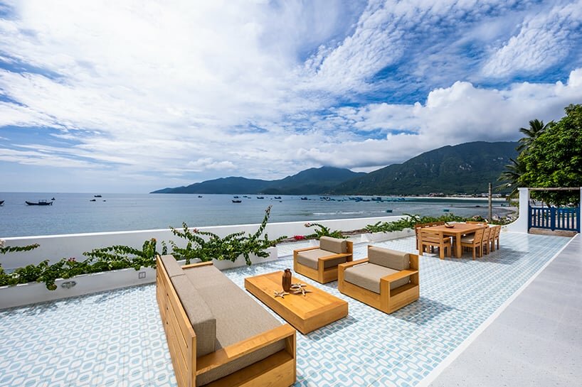 the outdoor tiling displays geometrical patterns in white and blue