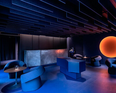 visual display immerses italian restaurant and bar lounge in neon orange light