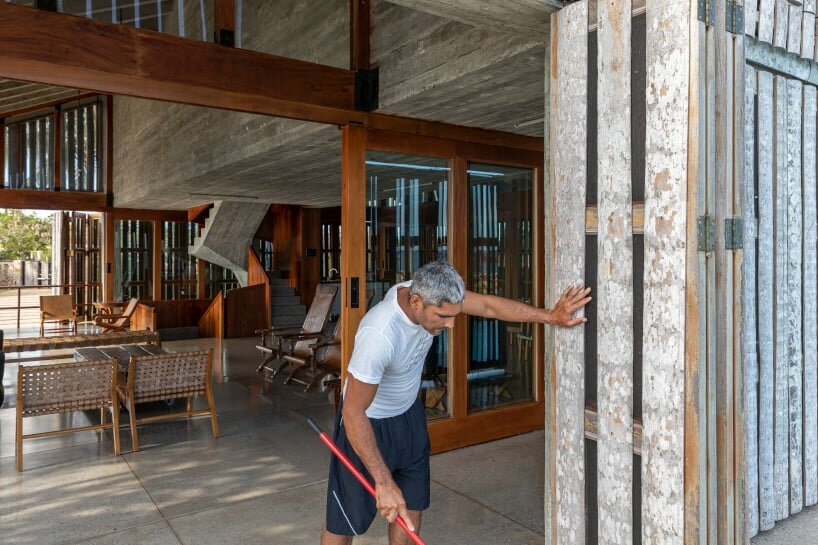 the wooden external skin enfolds a three-story house within