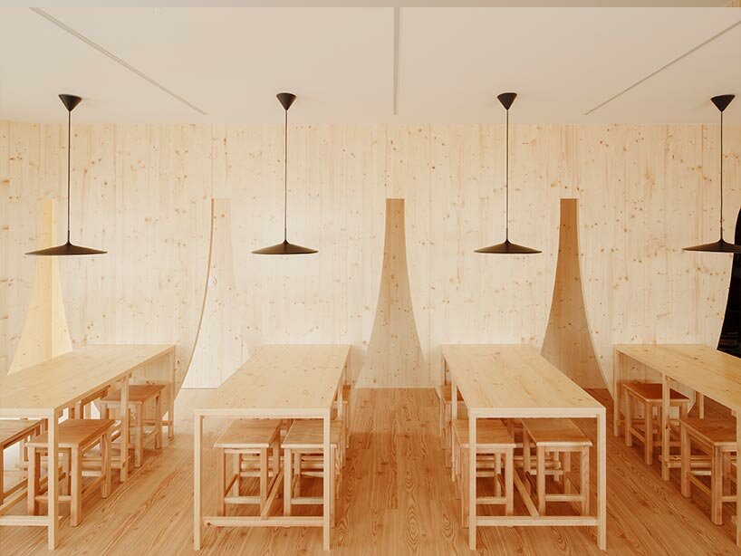 funnel-shaped cutouts finish snug restaurant in portugal