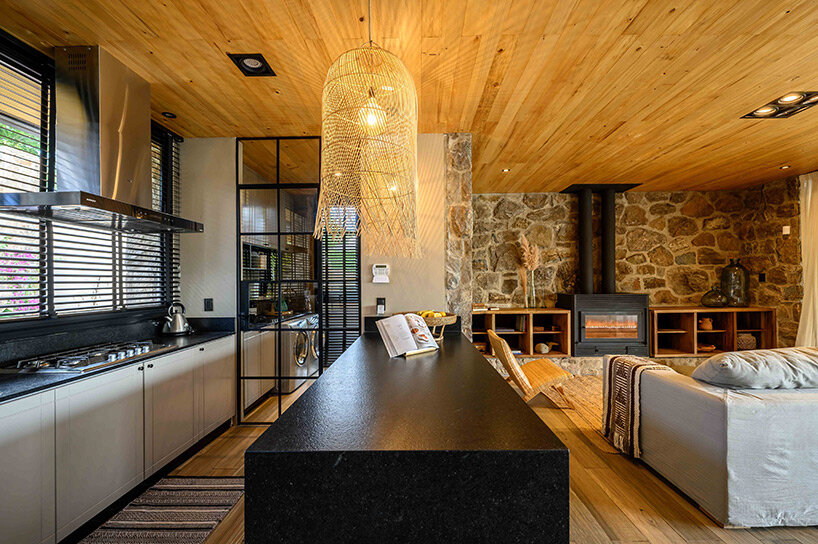 a house of stone dubbed ‘casa piedra’ shows warm interiors in argentina