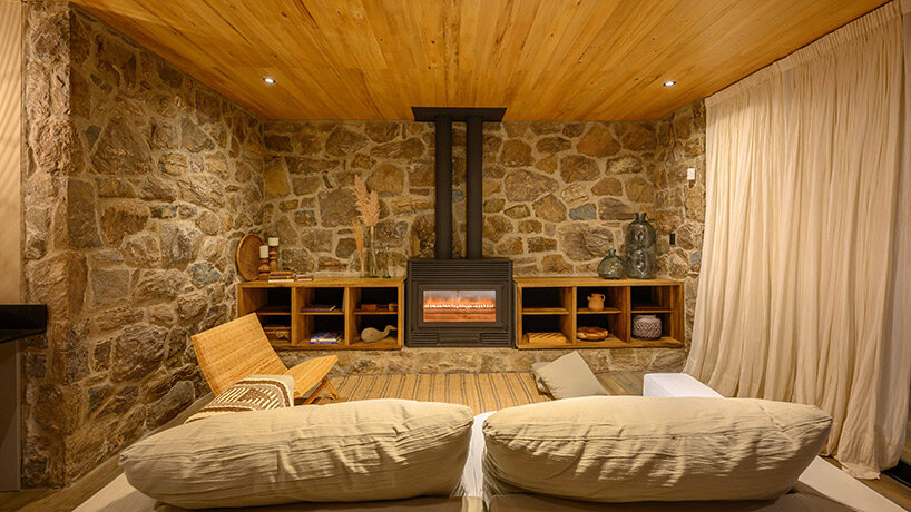 a house of stone dubbed ‘casa piedra’ shows warm interiors in argentina