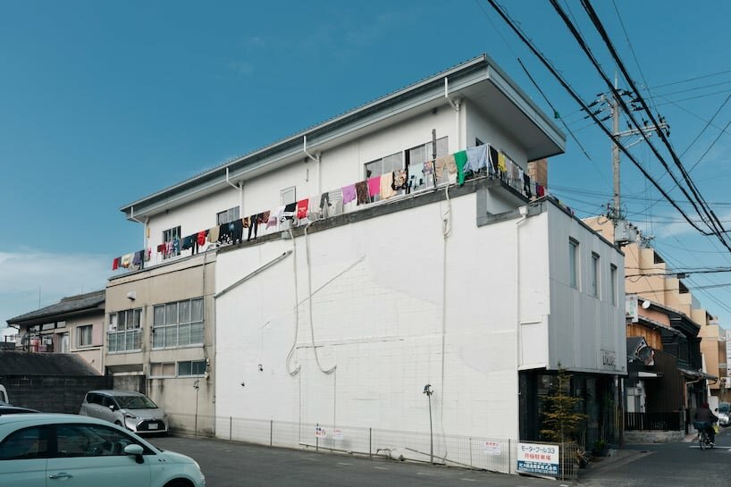from the outside, the building appears as a normal residence lined with laundry