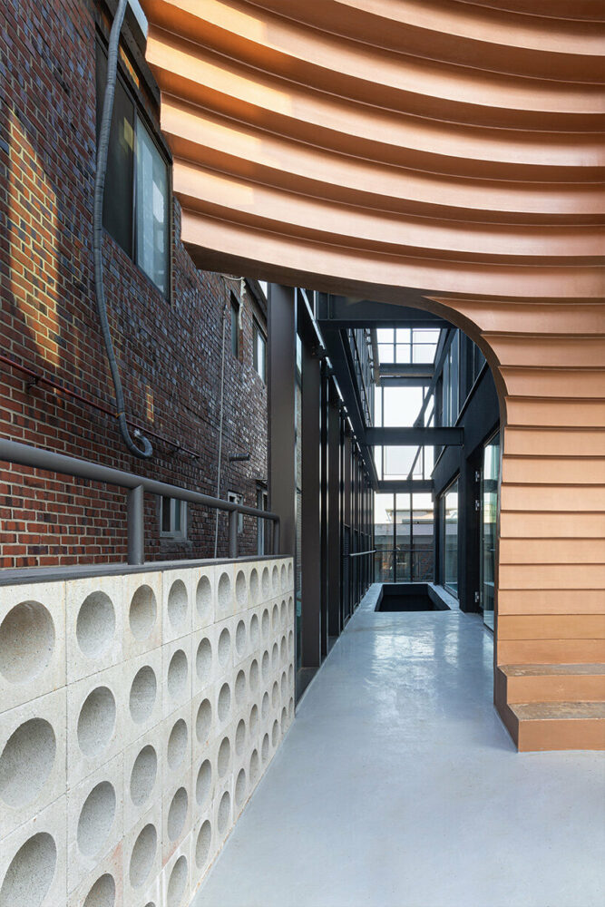 concrete cuts and curves pierce through moon hoon-renovated building in seoul