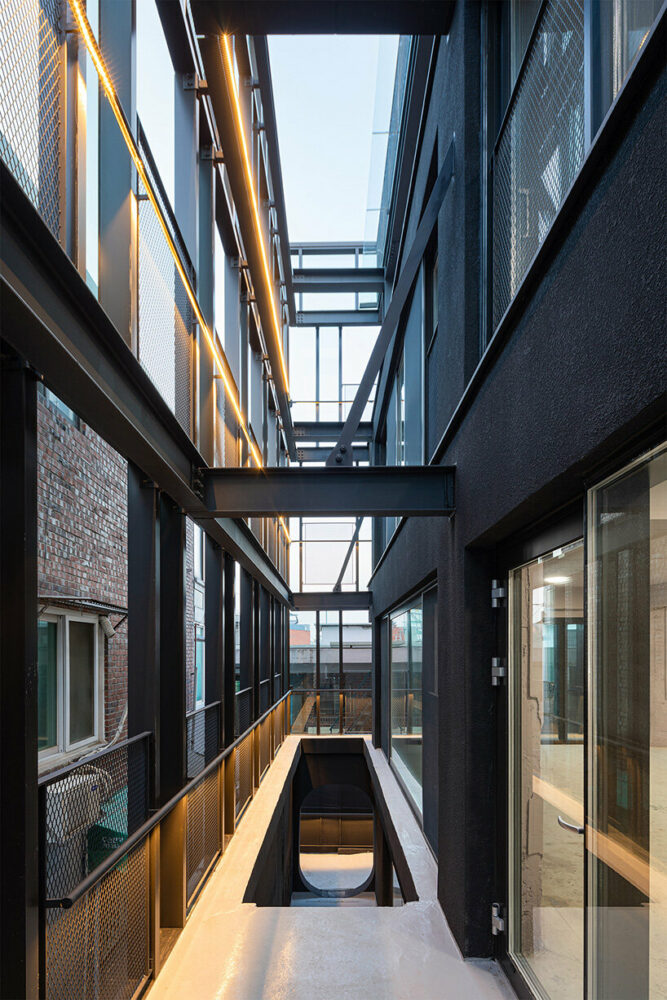 concrete cuts and curves pierce through moon hoon-renovated building in seoul