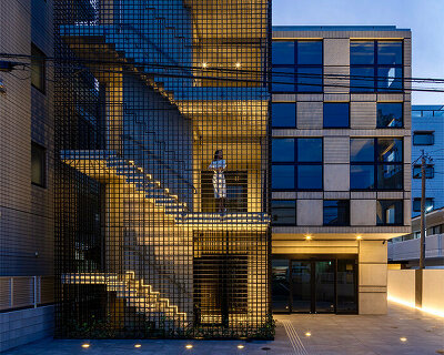 mosquito net-like latticework envelops SAKO's concrete multi-tenant building in japan