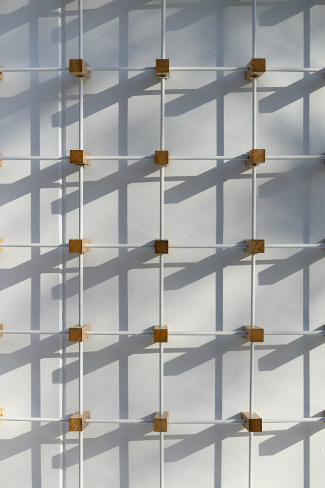 EFEEME arquitectos uplifts bakery façade in argentina with smooth iron and wooden props