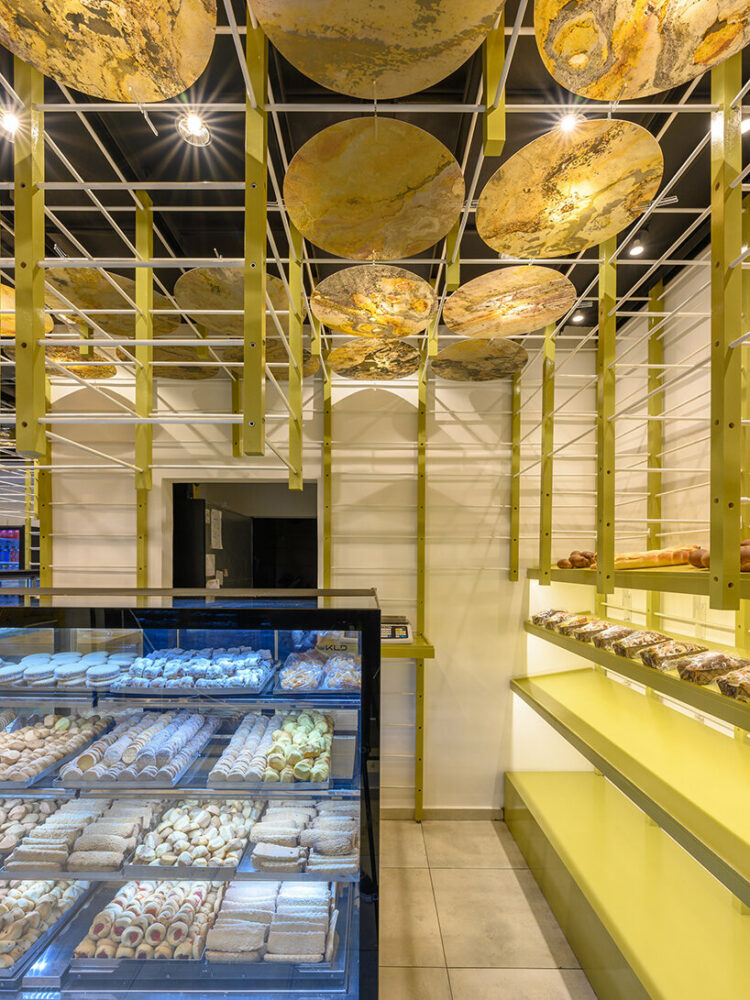 EFEEME arquitectos uplifts bakery façade in argentina with smooth iron and wooden props