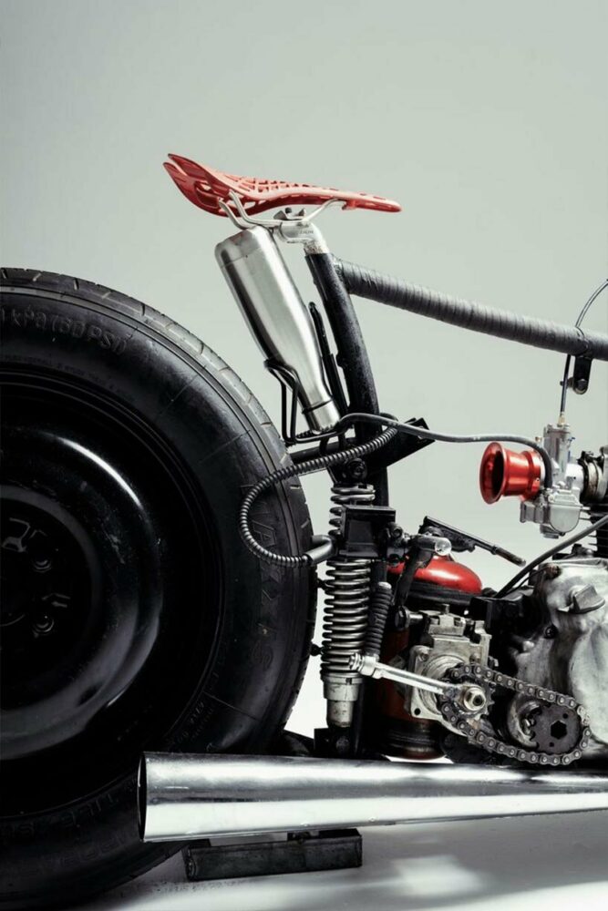 stripped motorcycle design combines spare car wheels, vintage kawasaki engine & bike seat
