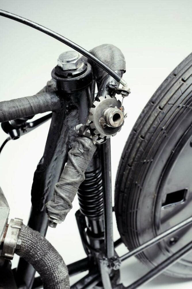 stripped motorcycle design combines spare car wheels, vintage kawasaki engine & bike seat