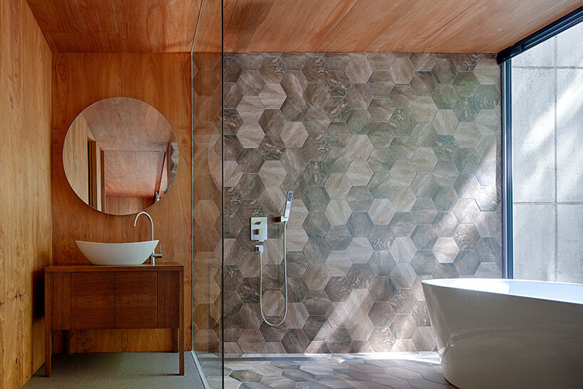 a minimalist retreat is nestled beneath the wooded mountains of korea