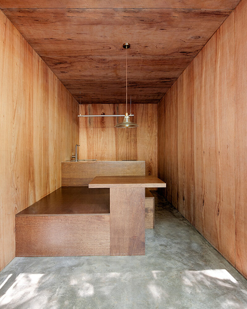 a minimalist retreat is nestled beneath the wooded mountains of korea